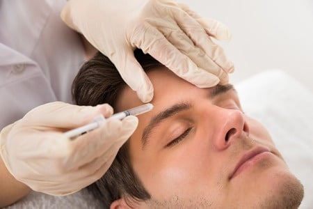 43306532 - young man having botox treatment at beauty clinic