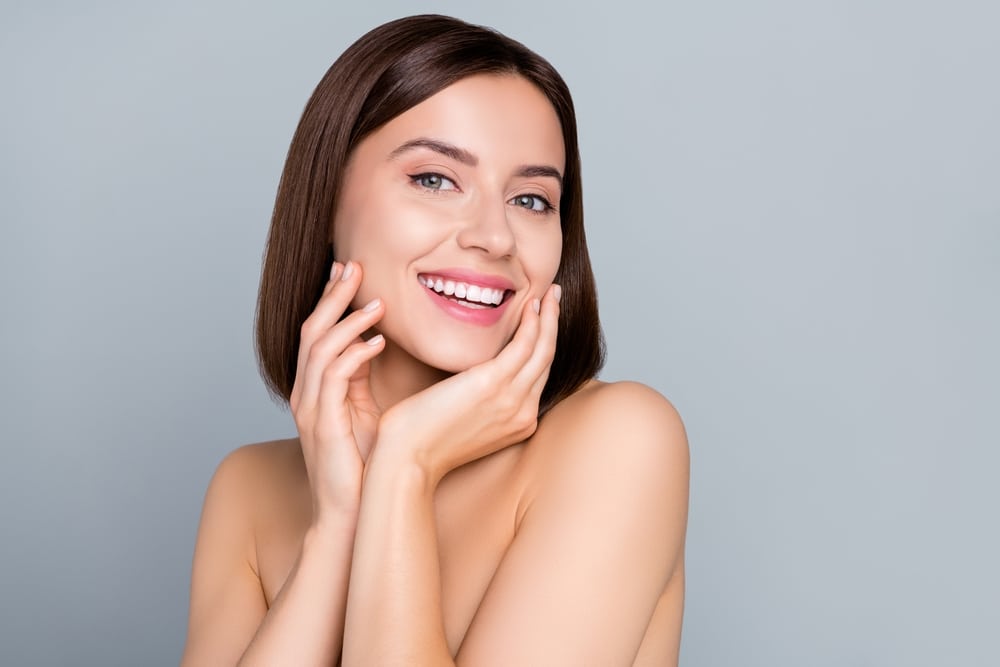 A woman smiling after using Allē Rewards at Utah Facial Plastics